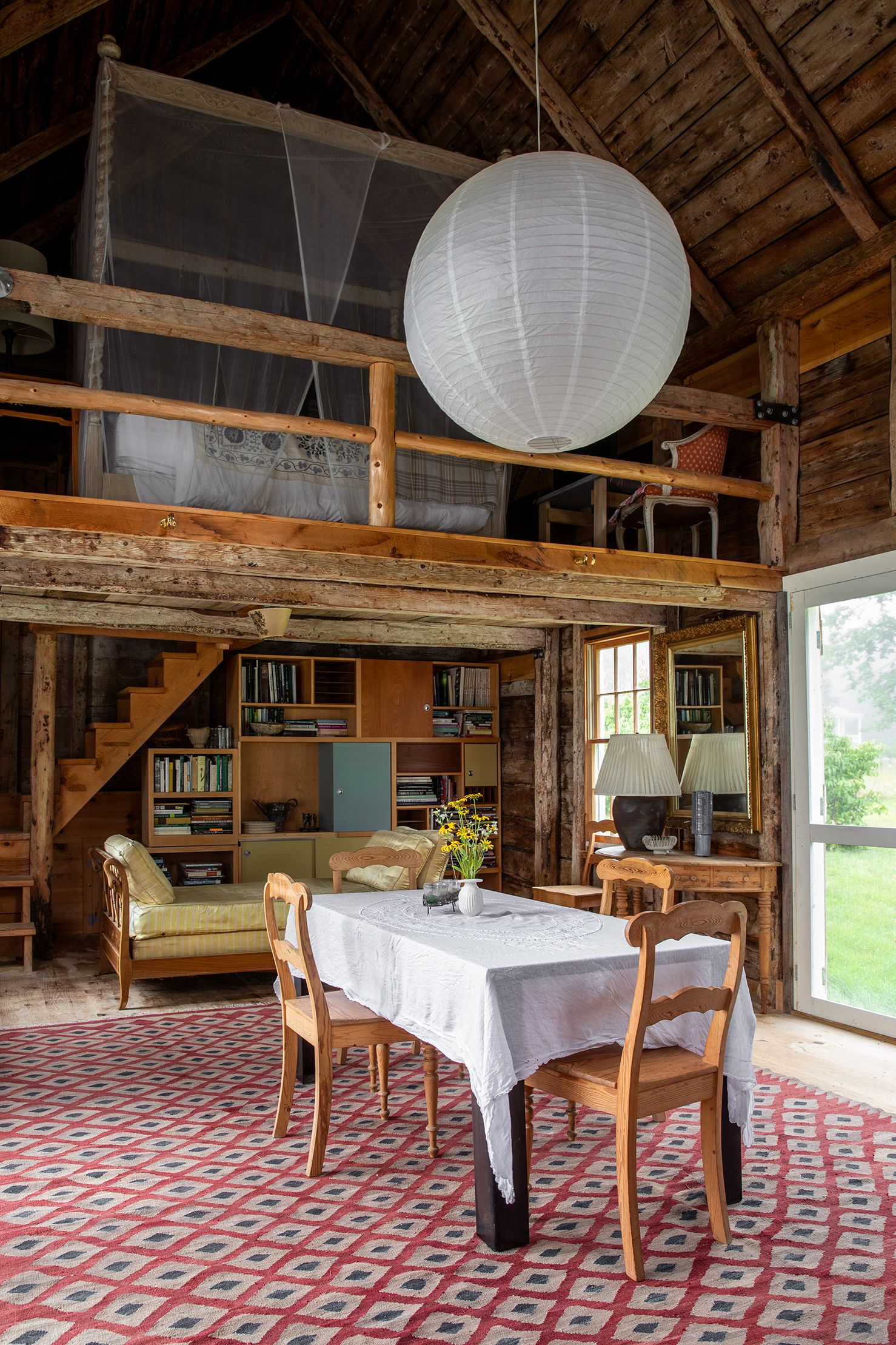 Image may contain Furniture Chair Wood Housing Building Indoors Hardwood Flooring Interior Design and Living Room