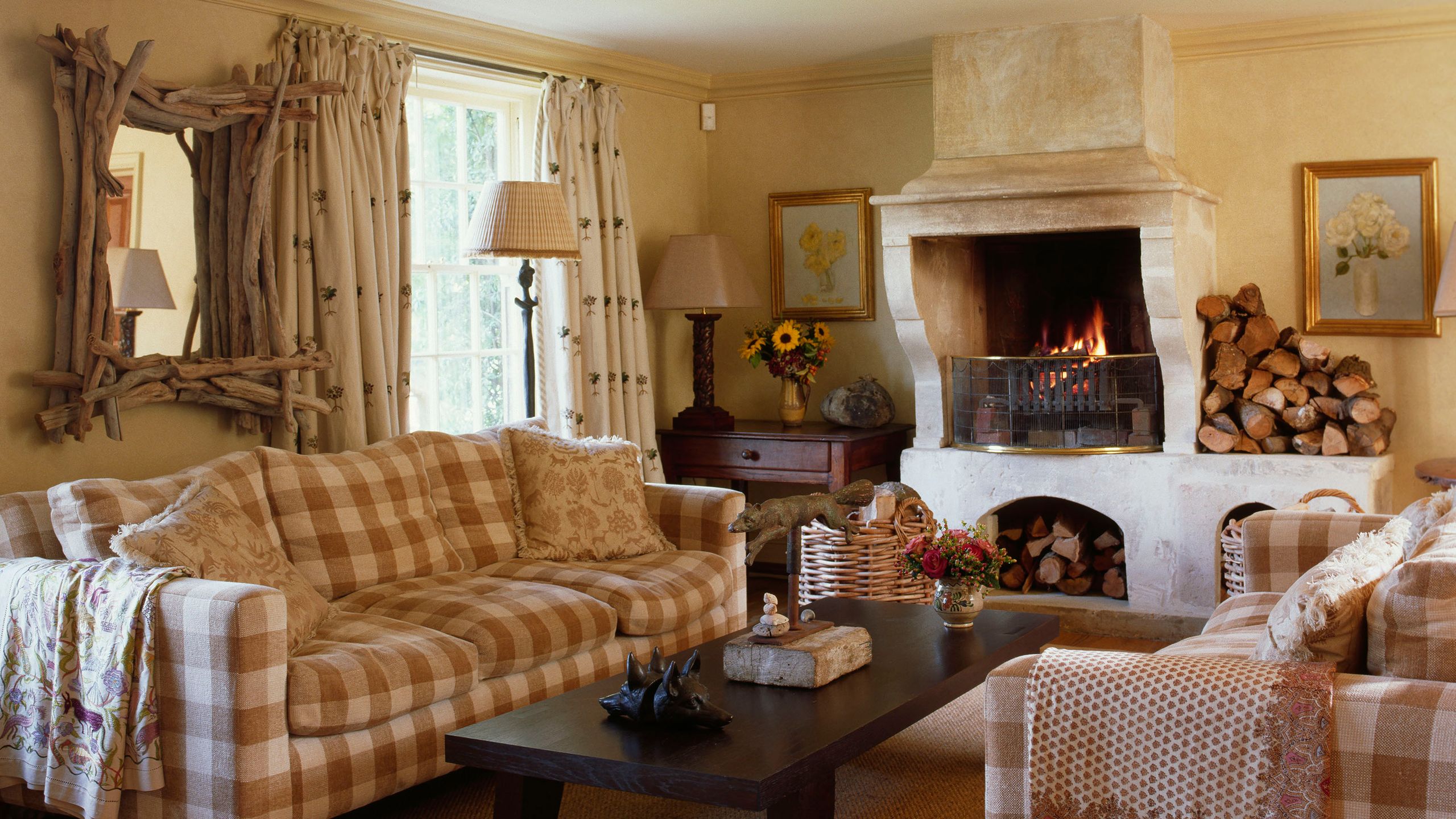 Image may contain Living Room Room Indoors Furniture Fireplace Table Hearth Couch Home Decor and Wood