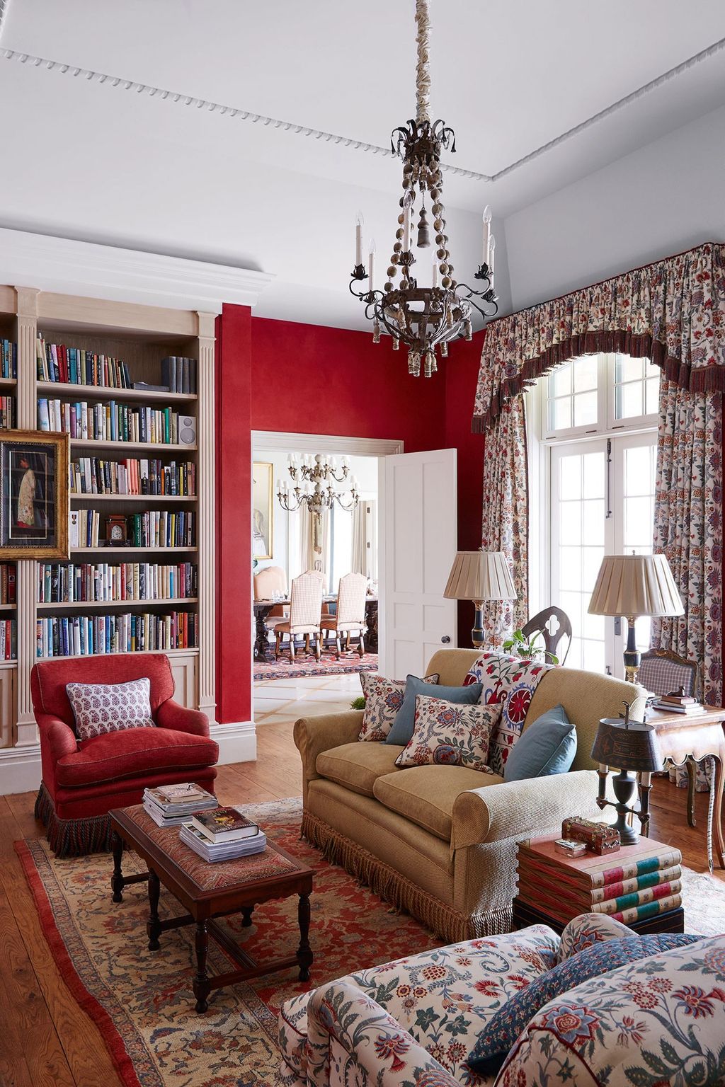 Image may contain Furniture Living Room Room Indoors Couch Rug Interior Design Table Bookcase Lamp and Chandelier