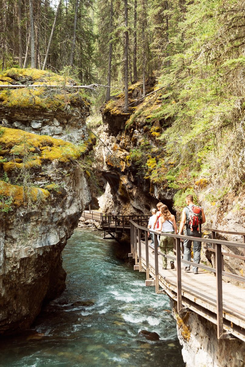 Image may contain Human Person Outdoors Nature Water Building Bridge Cliff and Path