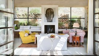 Image may contain Furniture Living Room Room Indoors Interior Design Rug Home Decor Table Couch Cushion and Pillow