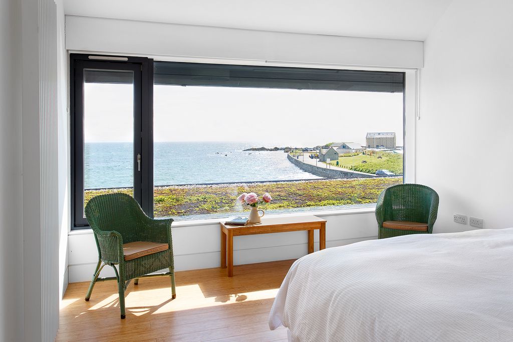 Image may contain Furniture Wood Flooring Interior Design Indoors Room Bedroom Hardwood Bed Floor and Housing