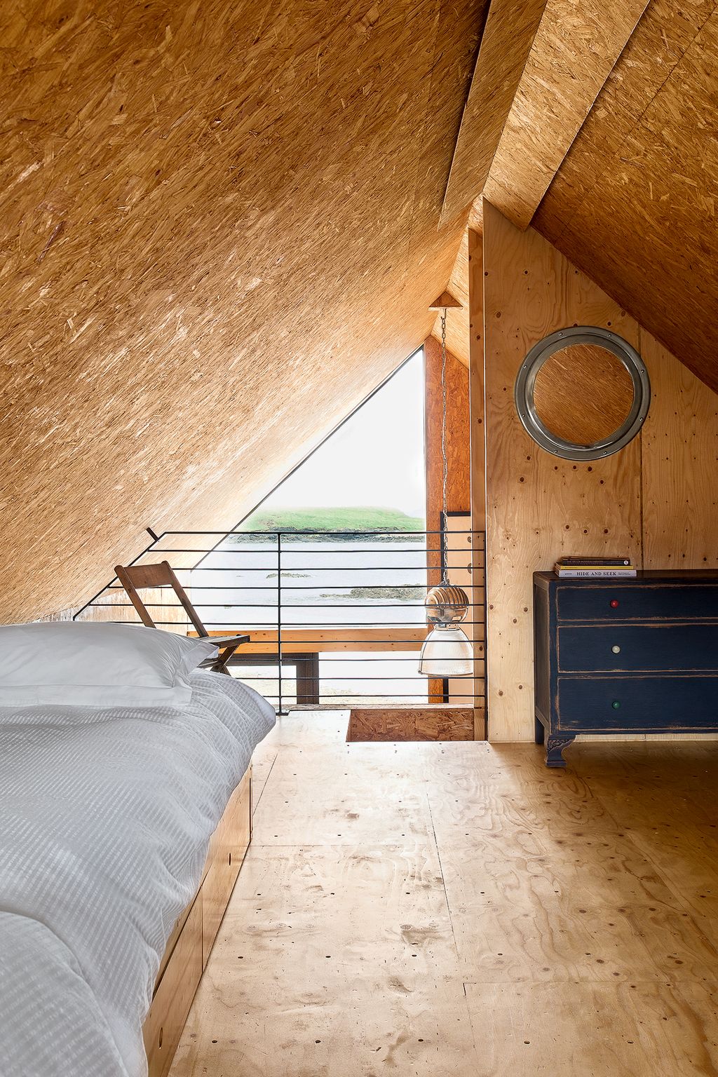 Image may contain Loft Housing Building Attic Indoors Wood Hardwood Interior Design Flooring Furniture and Bed