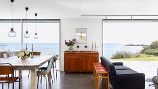 Image may contain Furniture Chair Flooring Indoors Interior Design Room Wood Living Room Hardwood Floor and Table