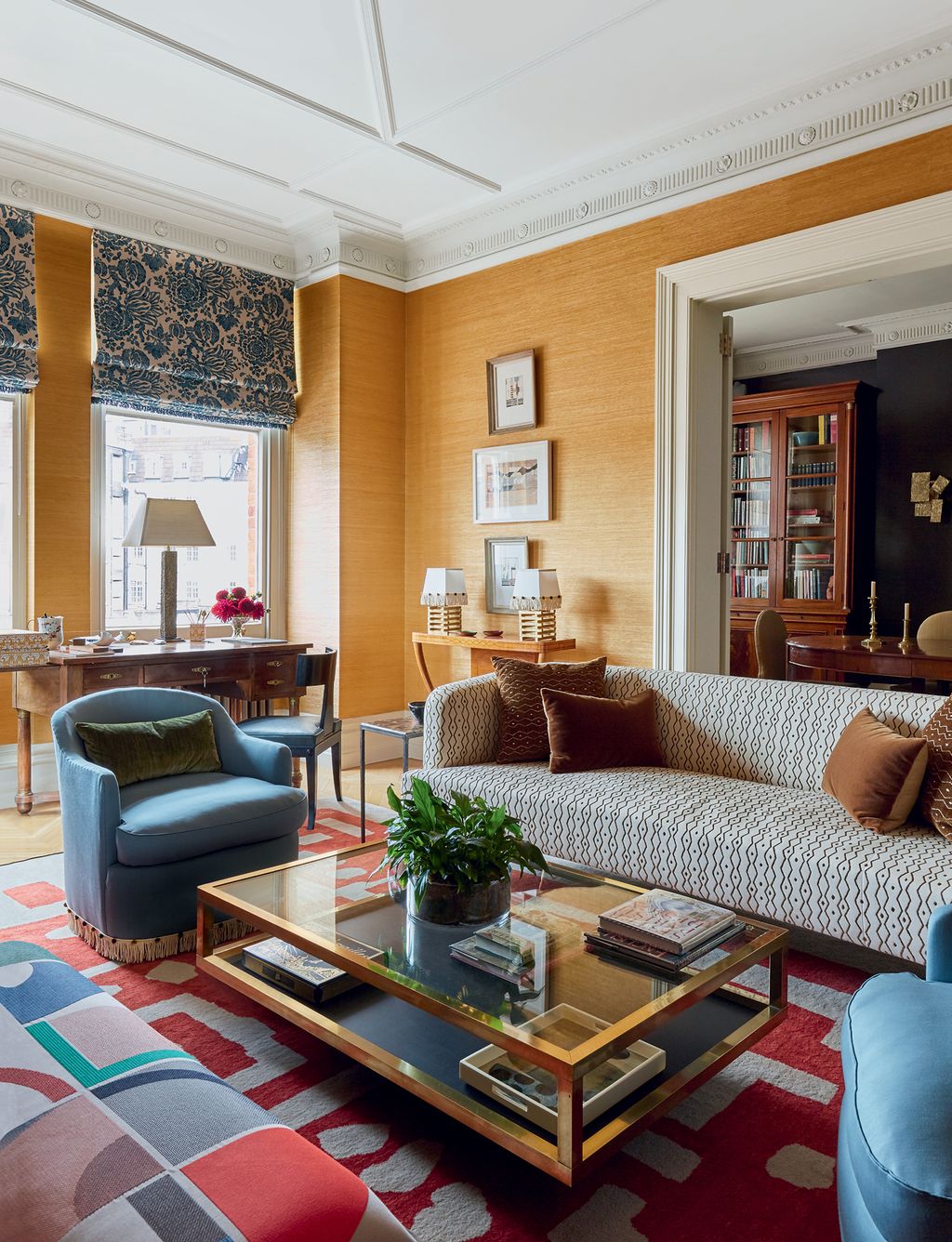 In this Tara Craig project grasscloth walls provide a rich backdrop for the ‘Eltham sofa by Ensemblier in Le Manachs...