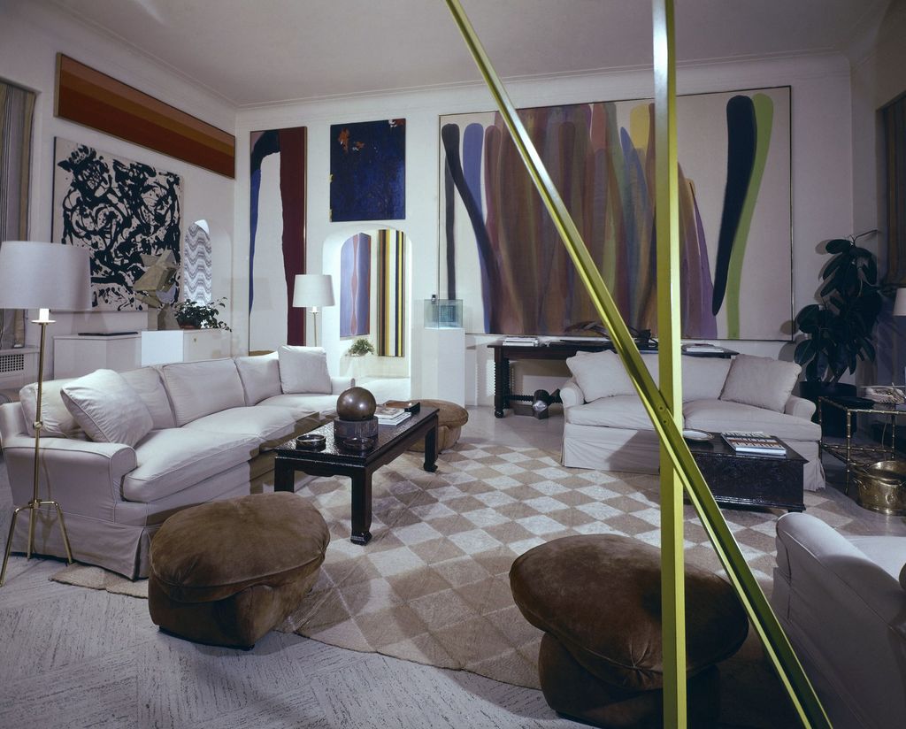 The green shafts of a Caro sculpture cut across an enormous Morris Louis in the living room. Above sofa a Kenneth Noland...