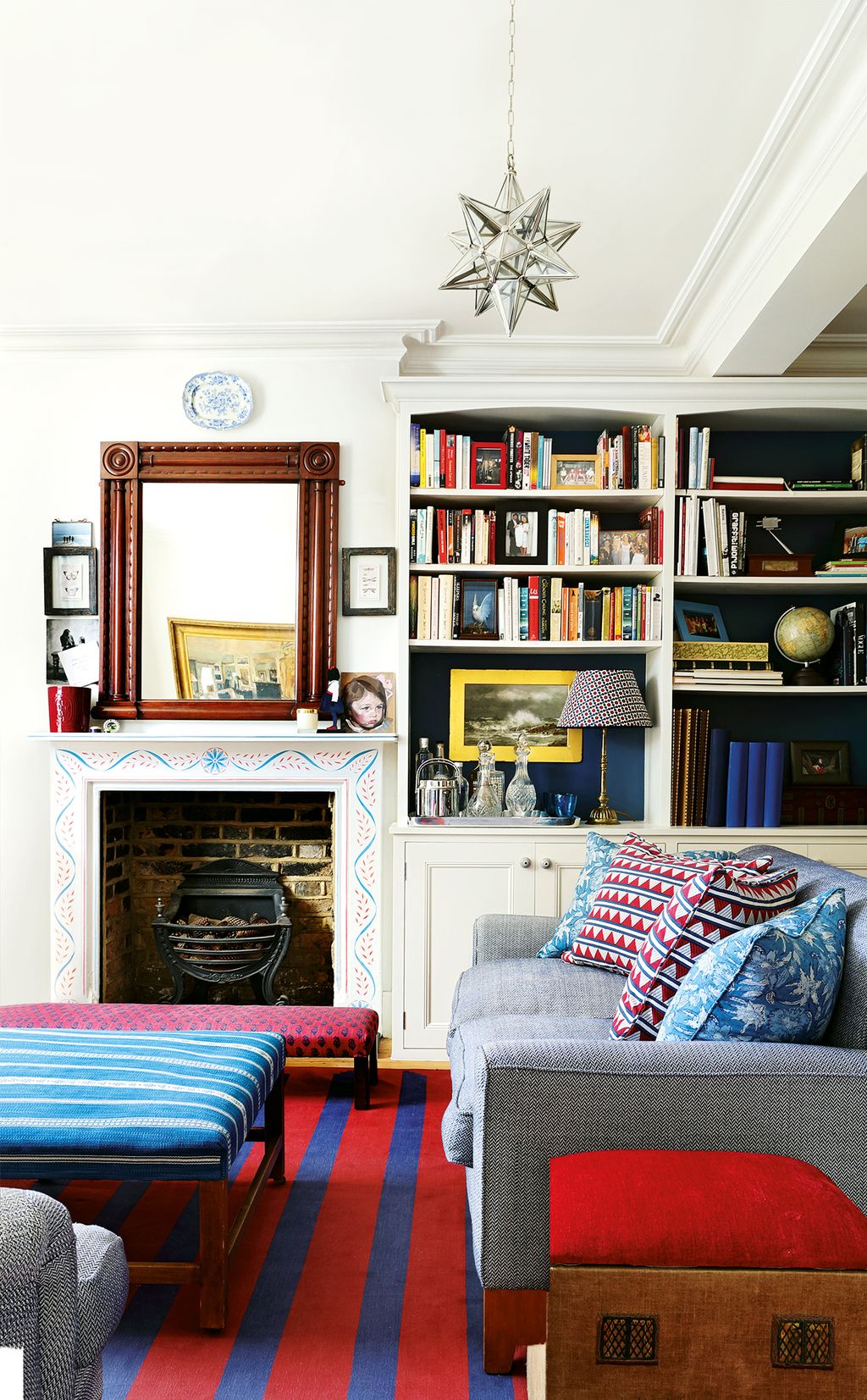 Image may contain Furniture Cushion Living Room Room Indoors Pillow Interior Design Couch Fireplace and Hearth