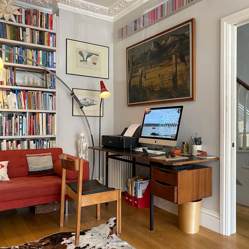 Image may contain Furniture Bookcase Living Room Room Indoors Wood Flooring Shelf Table and Interior Design