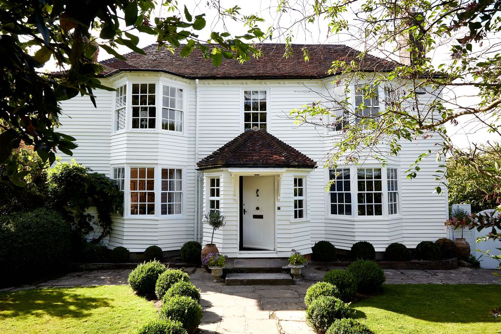 Image may contain Cottage House Building Housing Door Plant Grass and Roof
