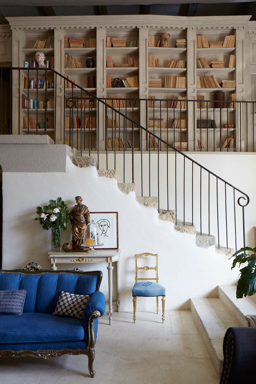 Image may contain Living Room Room Indoors Furniture Chair Interior Design Couch Cushion and Staircase