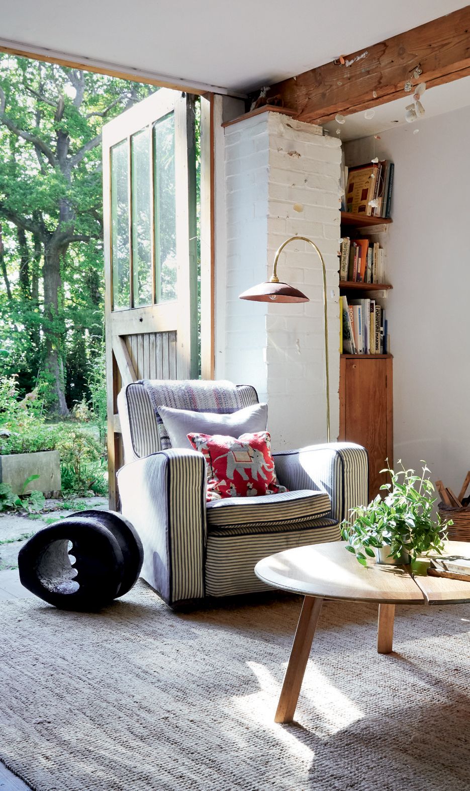 ‘KeelOver coffee table in brown oak and his brass and leather ‘MouldEd floor light bring stylish touches to the sitting...