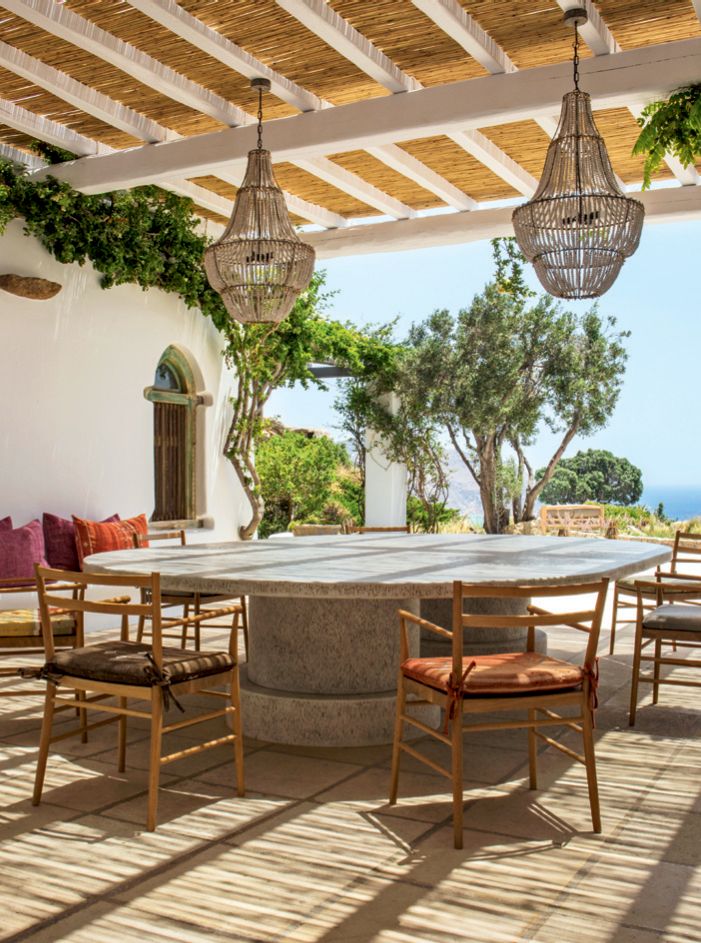 Image may contain Furniture Chair Patio Table Dining Table Porch Rug Indoors Tabletop Room and Pergola