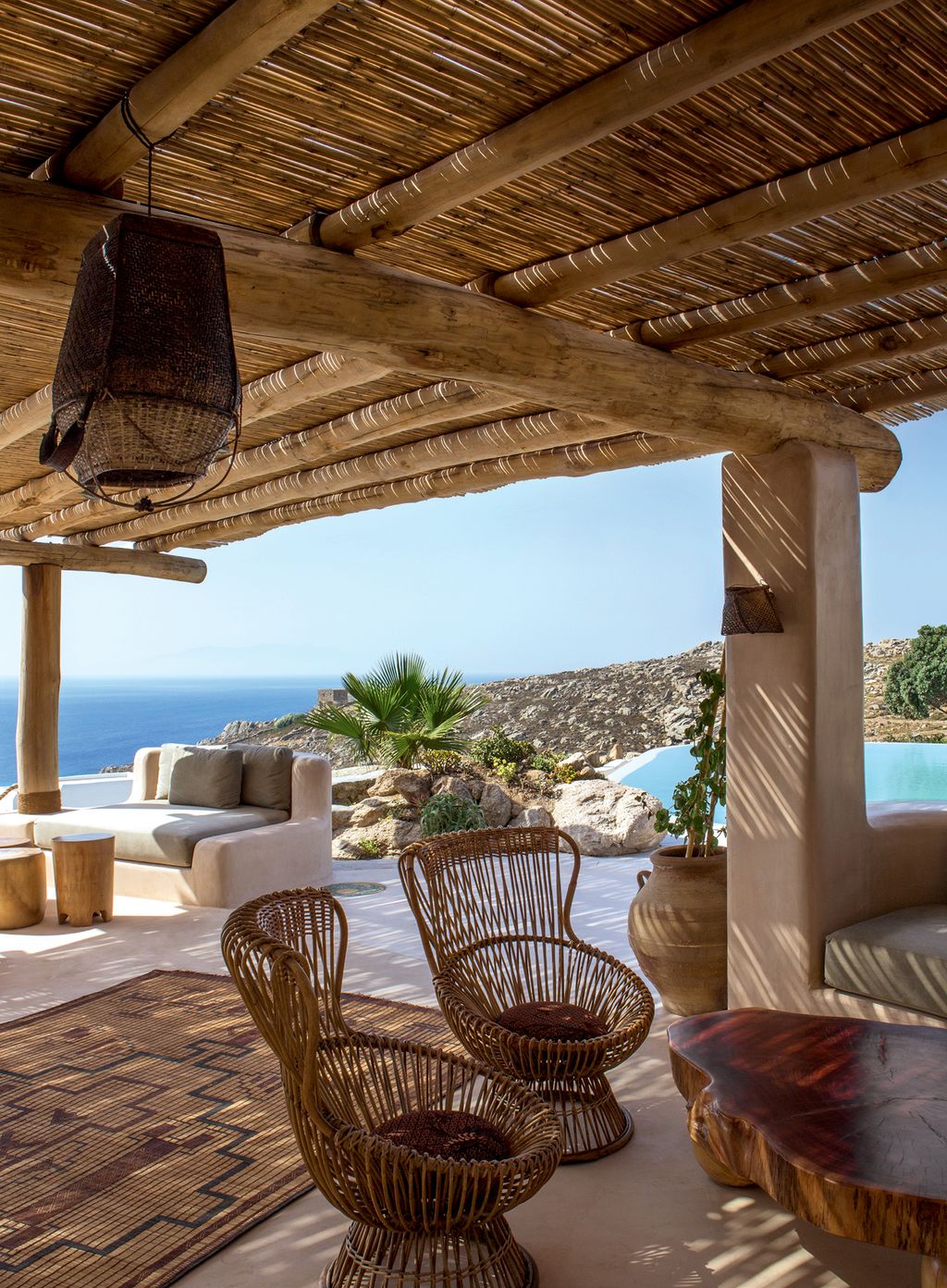 Image may contain Patio Porch Pergola Furniture Chair Wood Couch and Flooring