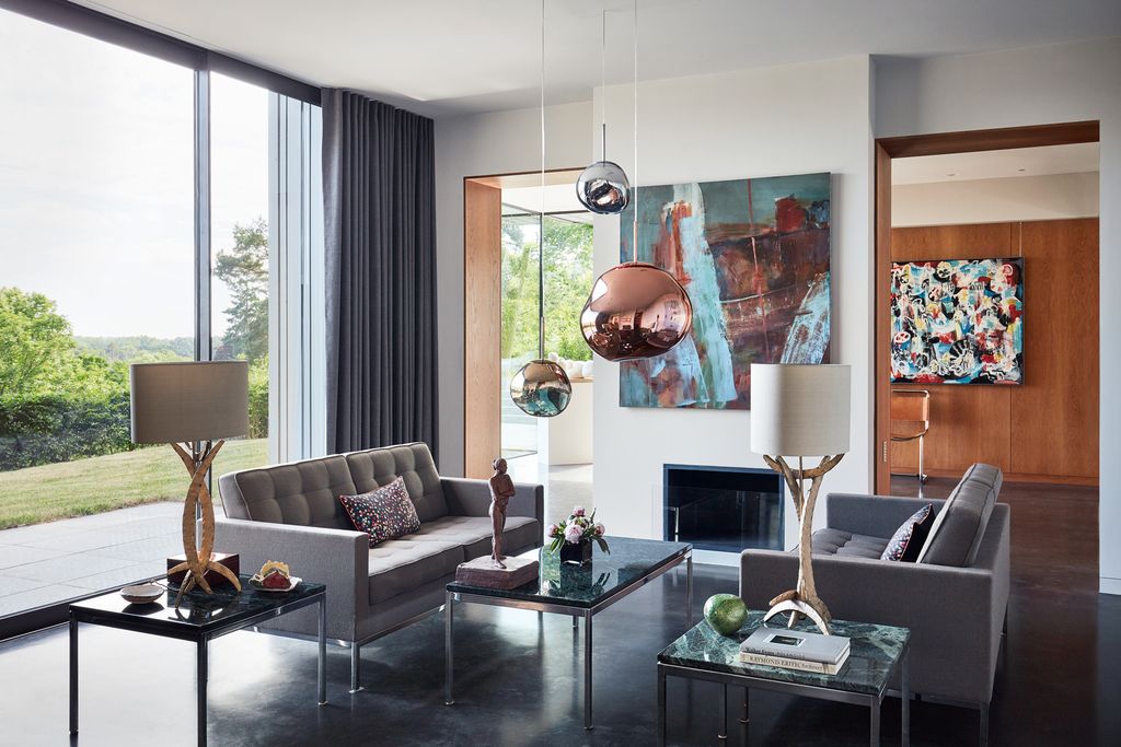 ‘Miro table lamps from Porta Romana sit beside the sofas.