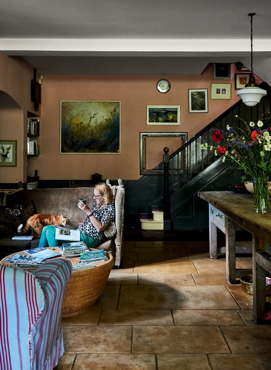 Image may contain Flooring Human Person Wood Furniture Couch Hardwood Living Room Room Indoors and Interior Design