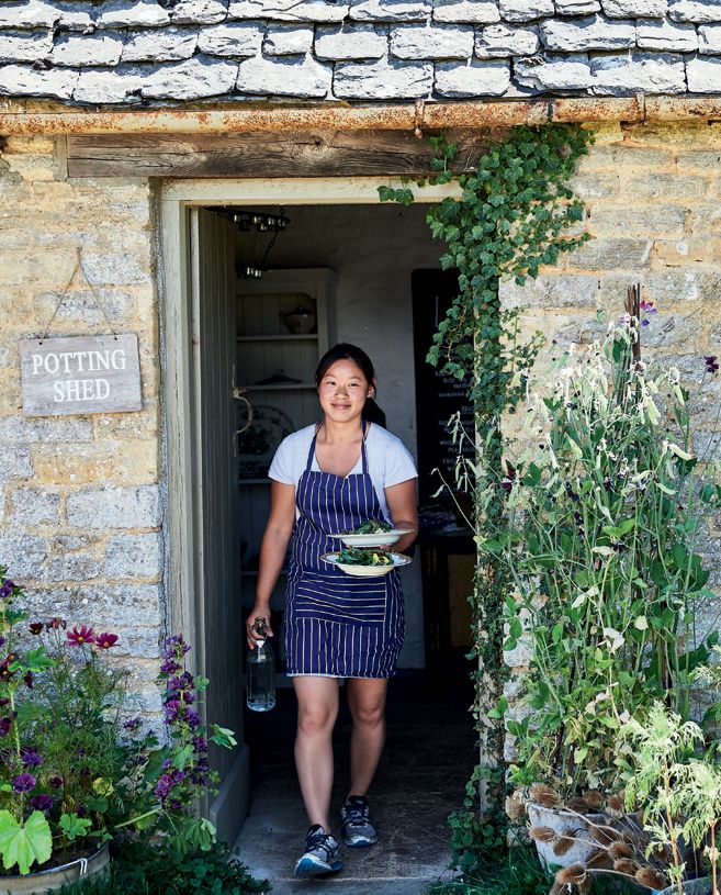 Image may contain Human Person Clothing Shoe Footwear Apparel Plant Outdoors Garden Vase Pottery and Potted Plant