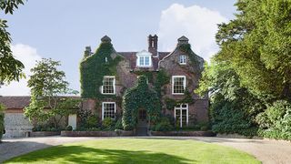 Image may contain Grass Plant Housing Building Lawn Cottage and House