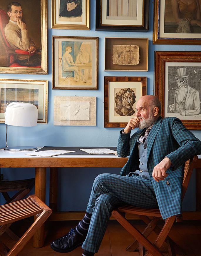 Barnaba sits before a wall of paintings by his father including a selfportrait .