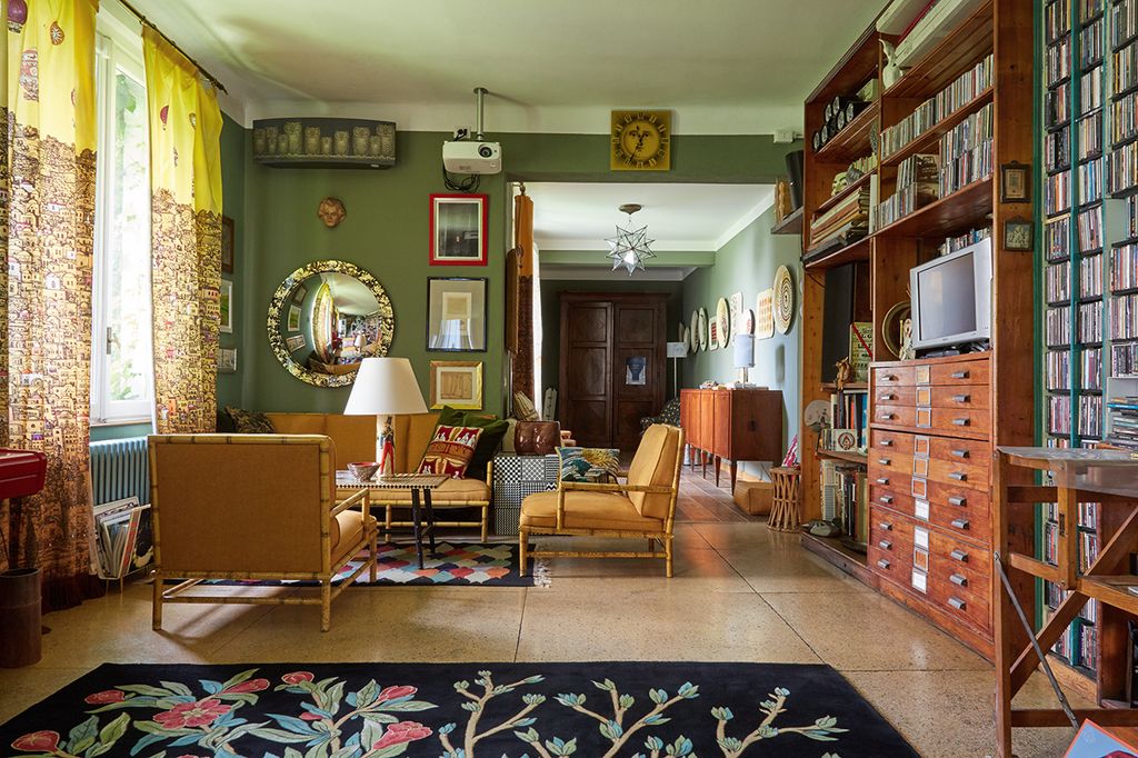 Image may contain Living Room Room Indoors Flooring Furniture Chair Interior Design Wood Hardwood Rug and Couch