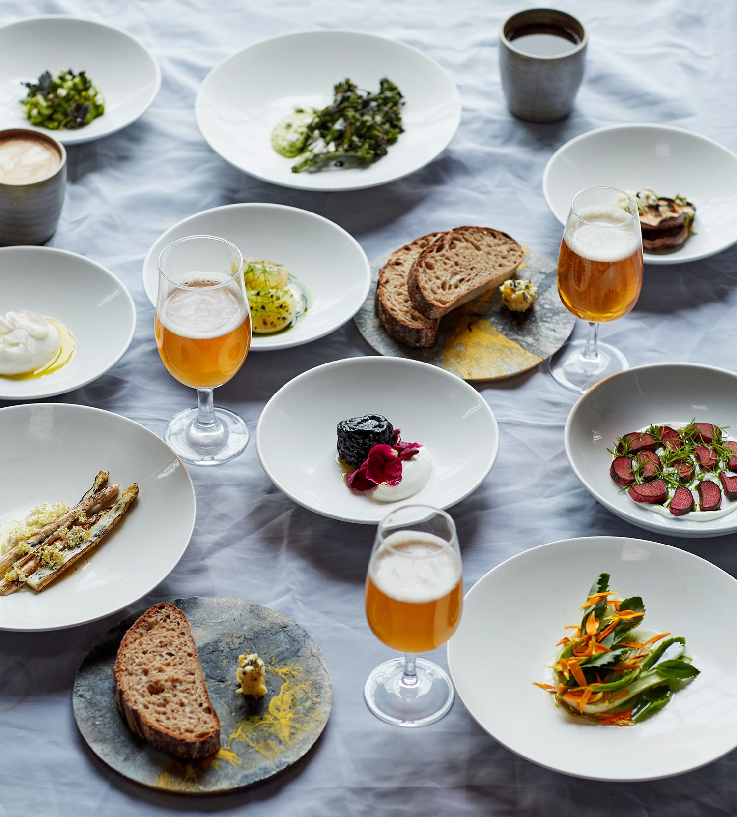 Image may contain Pottery Food Bread Saucer Furniture Dining Table Table and Plant