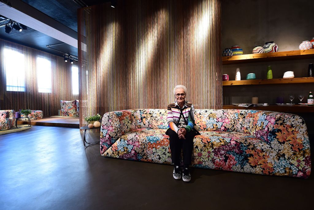 Image may contain Furniture Couch Human Person Living Room Room Indoors Interior Design Flooring Shelf and Wood