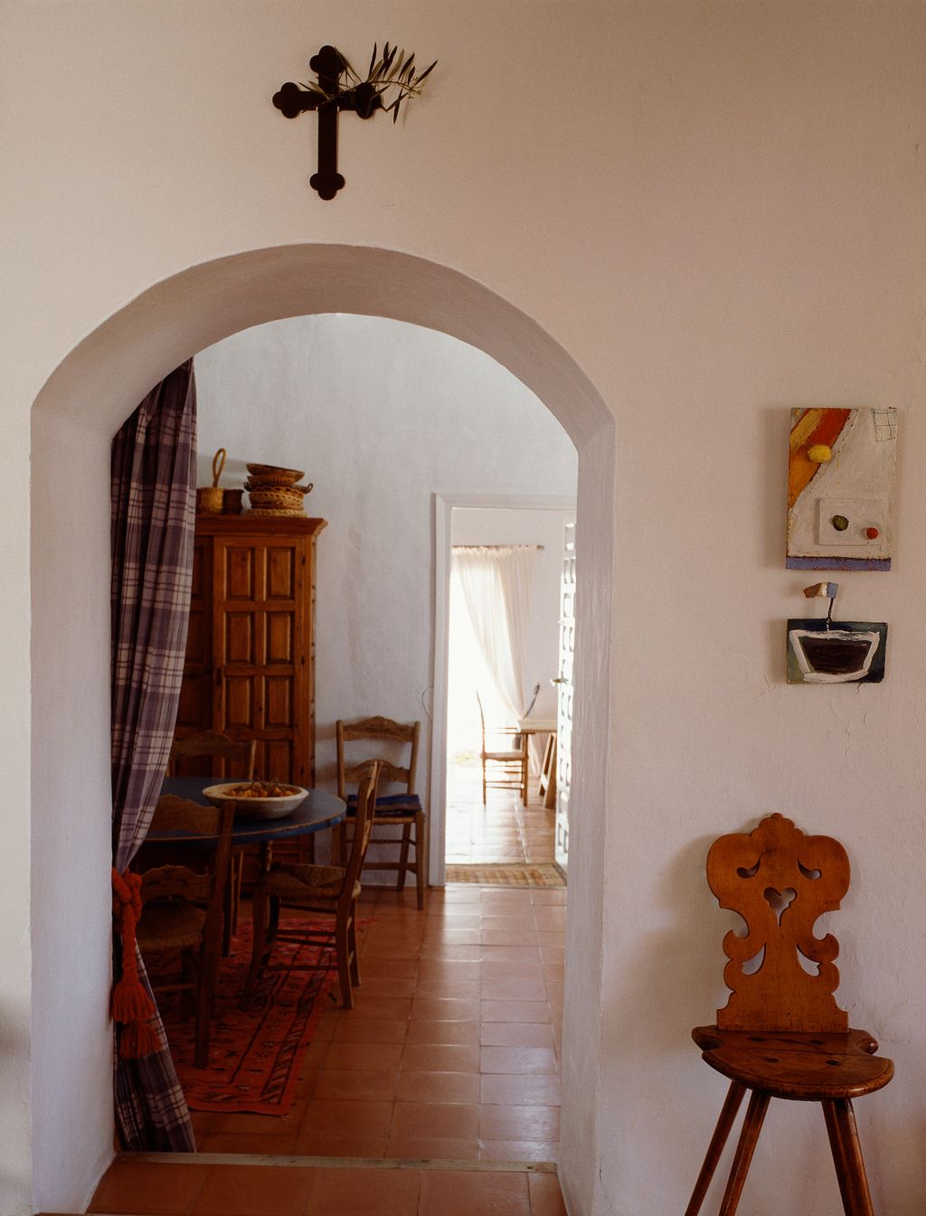 Looking from the sittingroom through the kitchen to the 'big' room at the end. A Lebanese iron cross hangs above the...