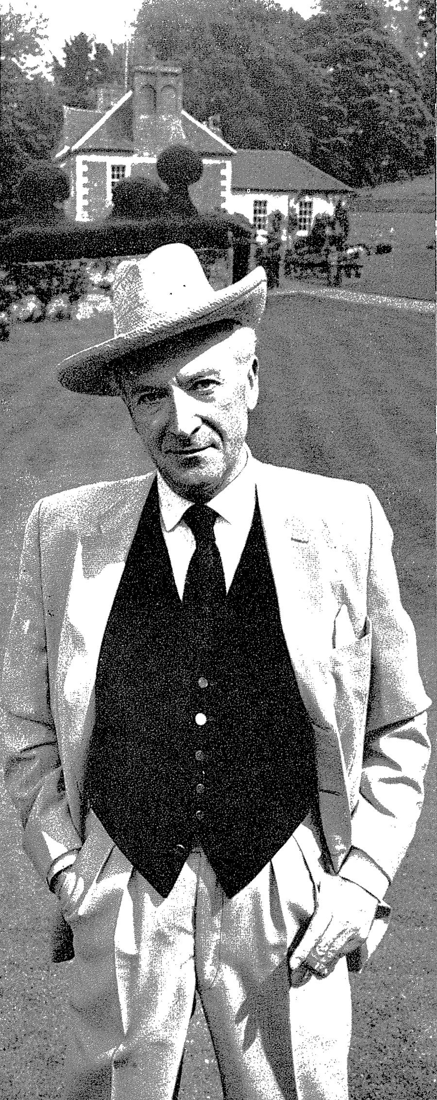 Image may contain Clothing Apparel Hat Human Person Face Tie Accessories Accessory Suit Coat Overcoat and Shirt