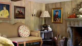 Image may contain Living Room Room Indoors Human Person Furniture Interior Design Wood Couch and Hardwood