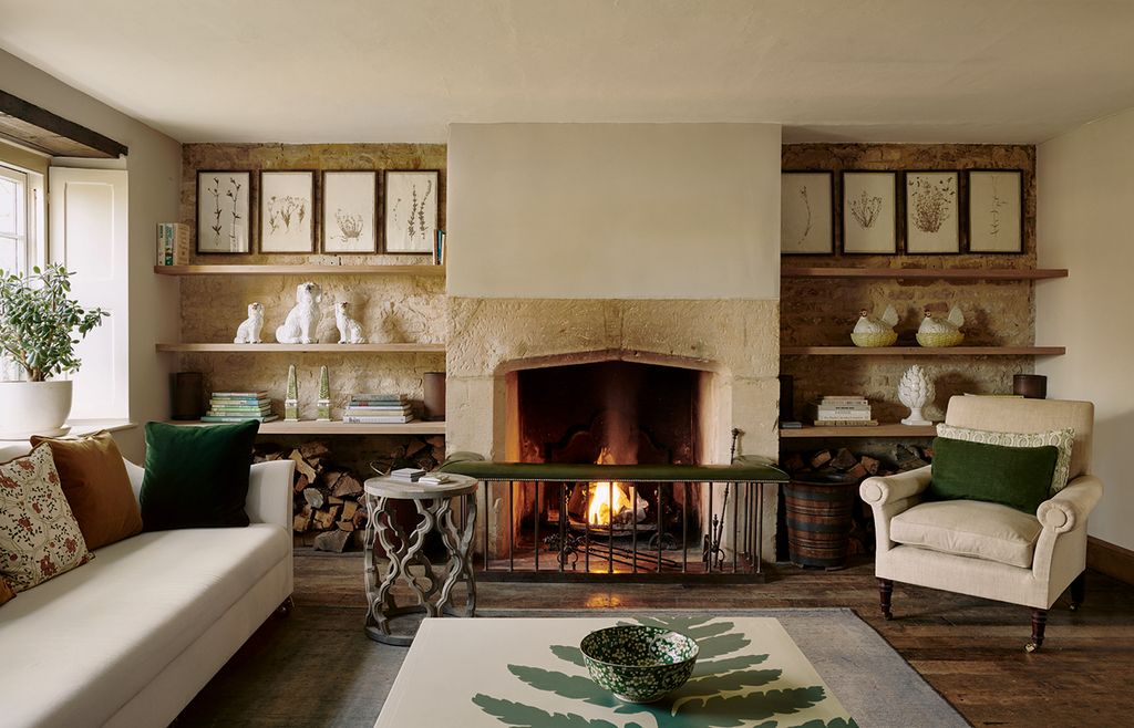 Image may contain Living Room Room Indoors Furniture Couch Fireplace Interior Design Hearth and Rug