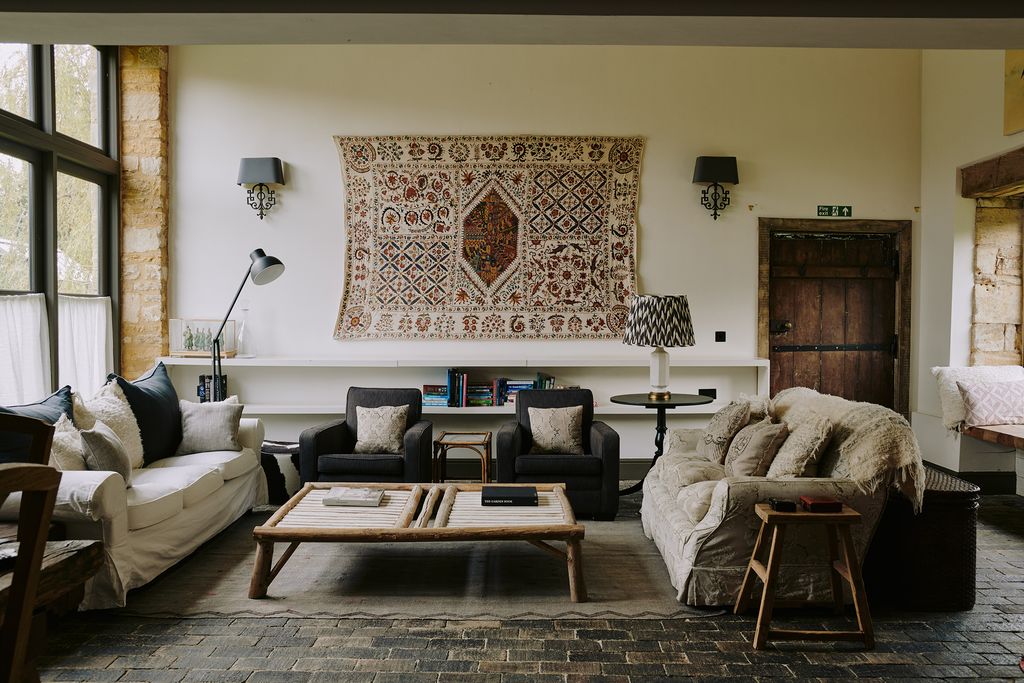 Image may contain Living Room Room Indoors Furniture Couch Table Coffee Table and Rug
