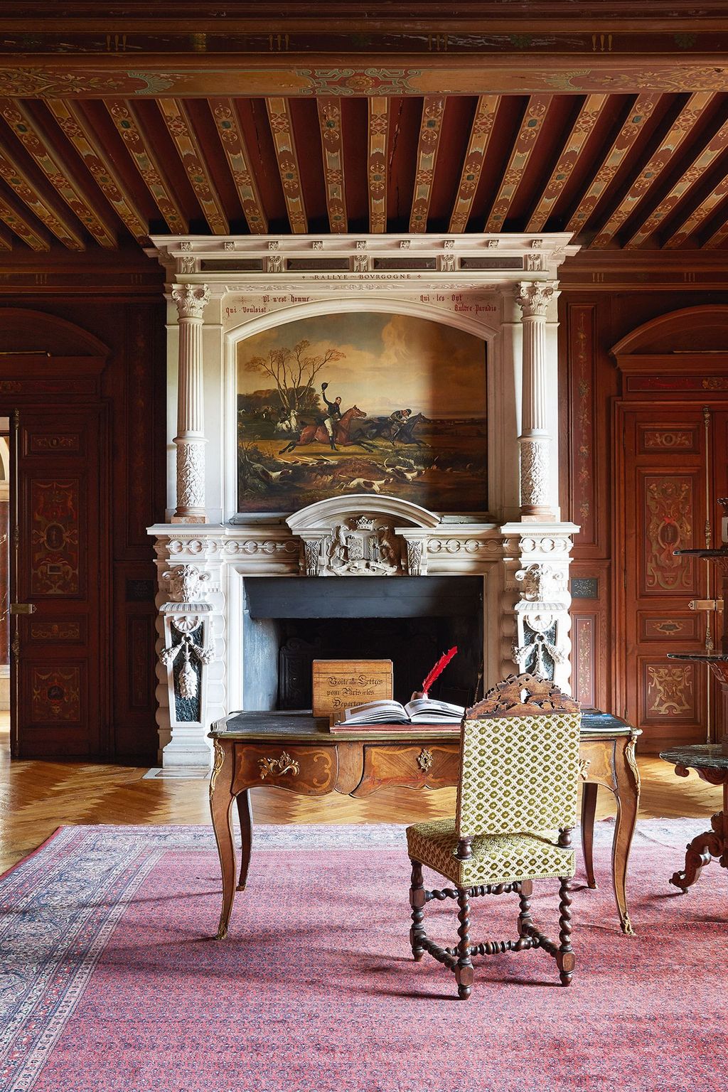 Image may contain Furniture Chair Indoors Fireplace Room Living Room Hardwood Wood Hearth and Home Decor