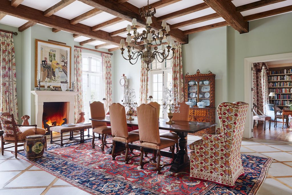 Image may contain Indoors Room Furniture Chair Rug Living Room Dining Room Fireplace and Interior Design