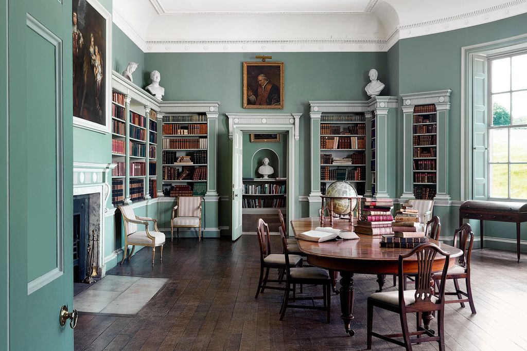 Image may contain Furniture Chair Shelf Indoors Room Flooring Interior Design Bookcase Living Room Floor and Wood