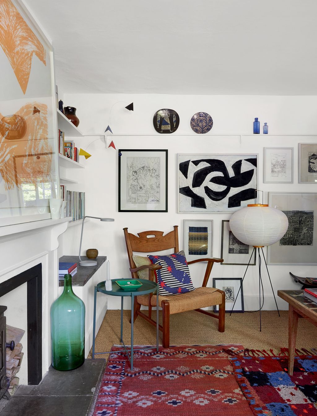 Image may contain Living Room Room Indoors Interior Design Rug Furniture Shelf and Flooring