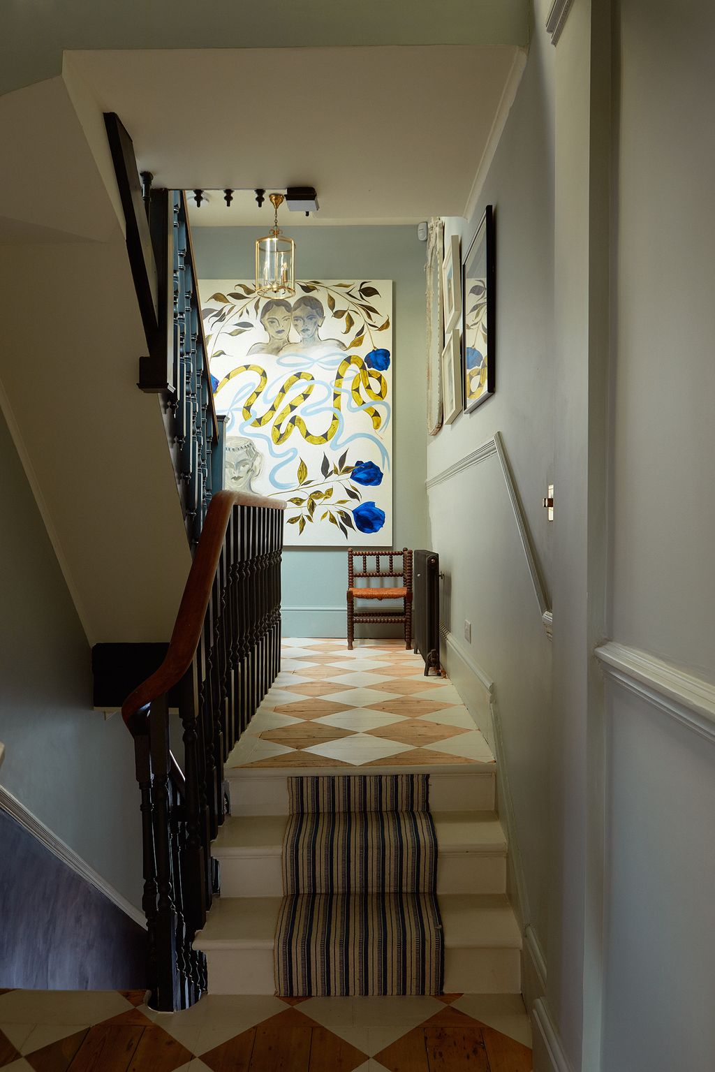 Image may contain Flooring Banister Handrail Floor Hardwood Wood Staircase Interior Design Indoors and Corridor