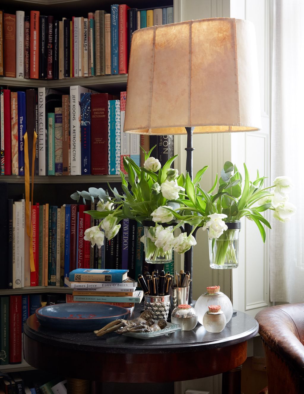 Image may contain Furniture Shelf Bookcase Table and Pottery