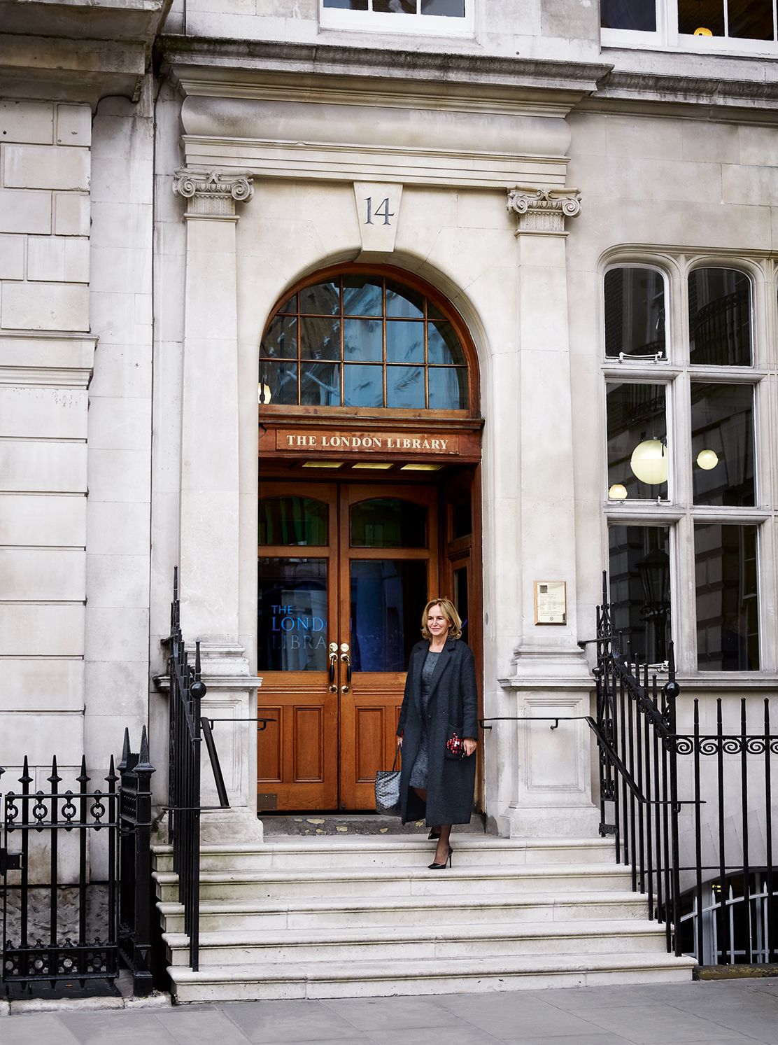 Image may contain Railing Banister Handrail Human Person Clothing Apparel Pants and Door