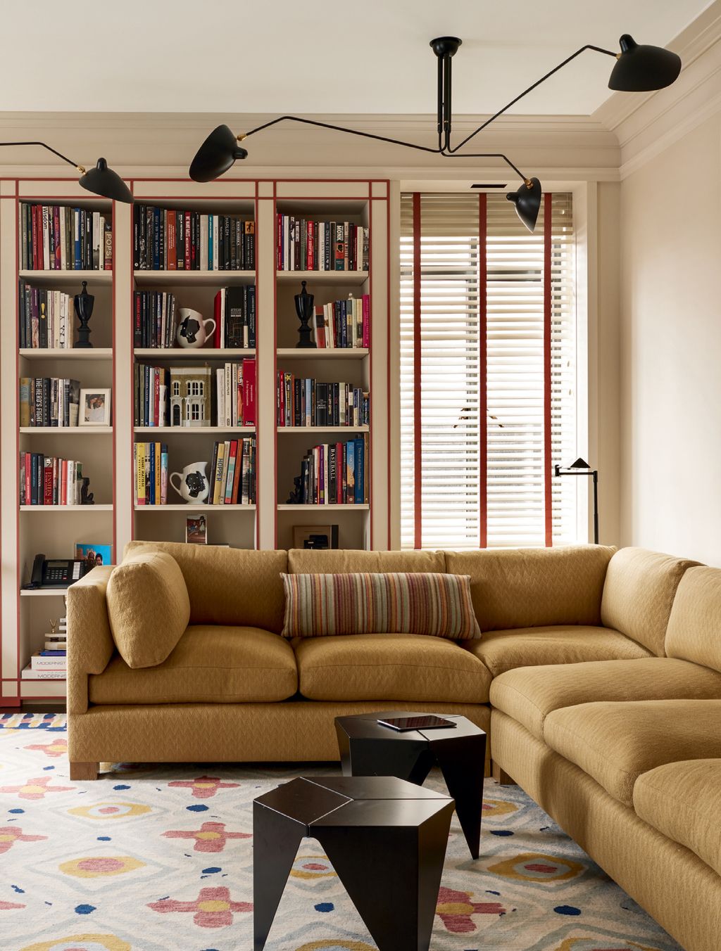 Image may contain Furniture Living Room Indoors Room Table Couch Bookcase Rug and Interior Design