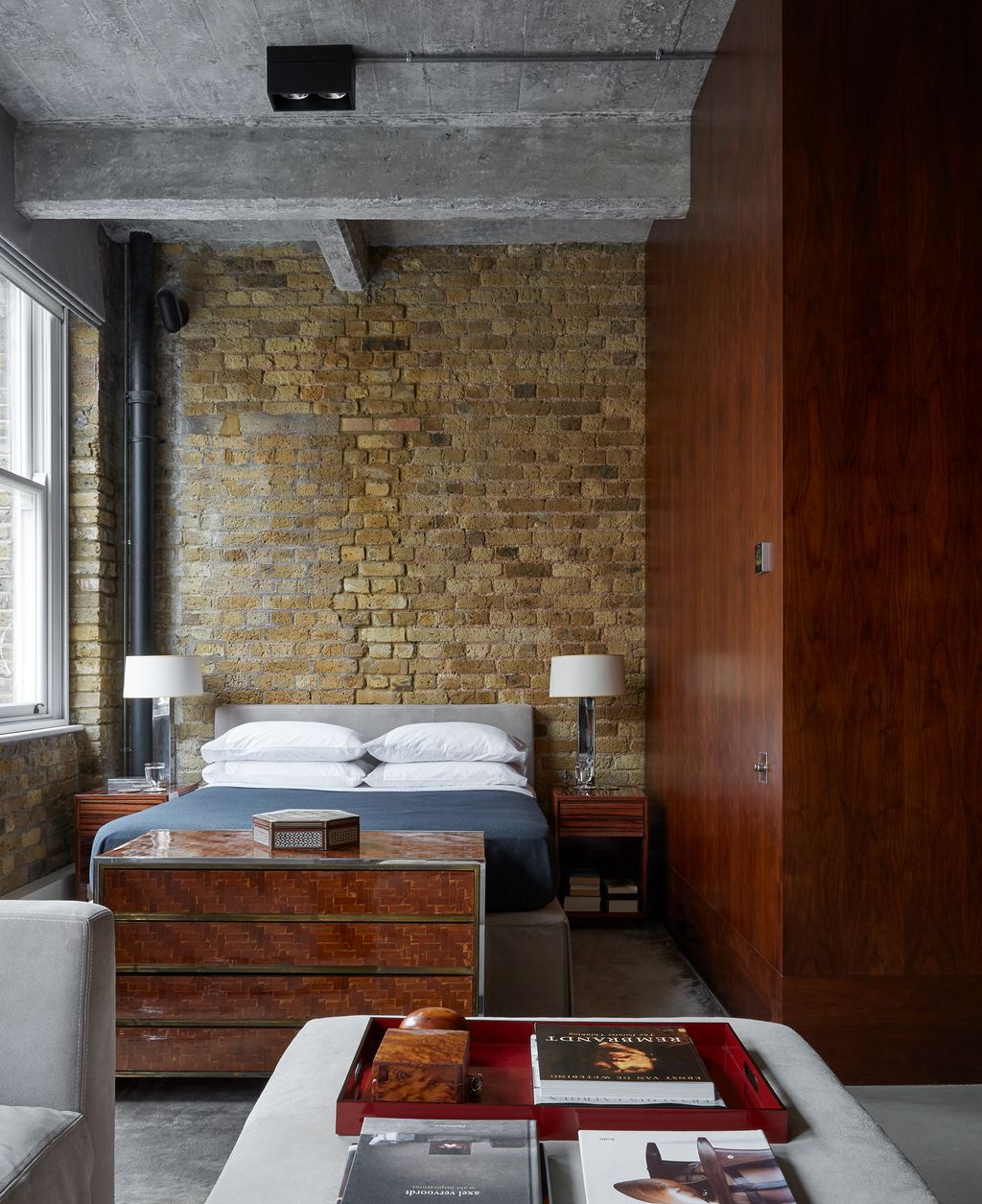 A 1960s Italian dresser bought on the Pimlico Road divides the sitting room from the sleeping area. 1970s chrome lamps...