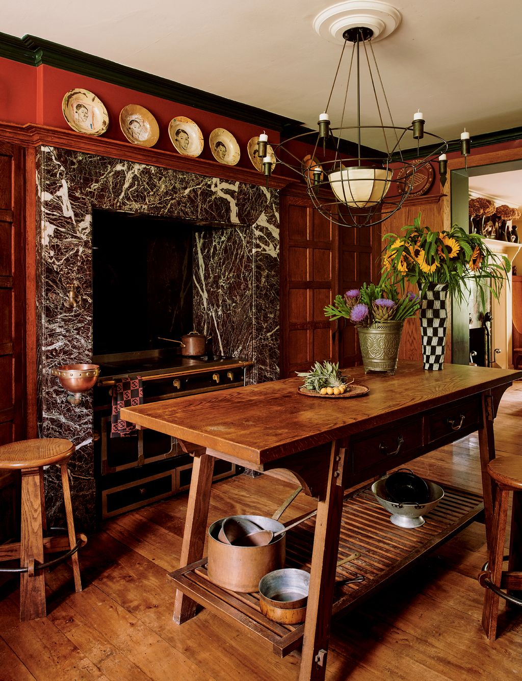 A light by Mark Kirkley hangs above an oak table made by Matthew Collins to Anthonys design. Plates by Margy Malan are...