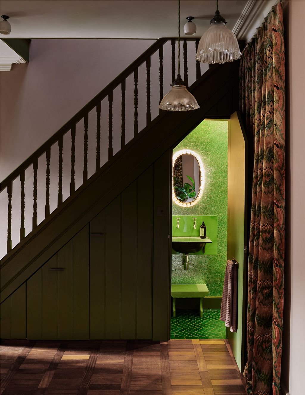 This jewel box under the stairs designed by Retrouvius was created using a quartet of greens. An enamelled wash basin...