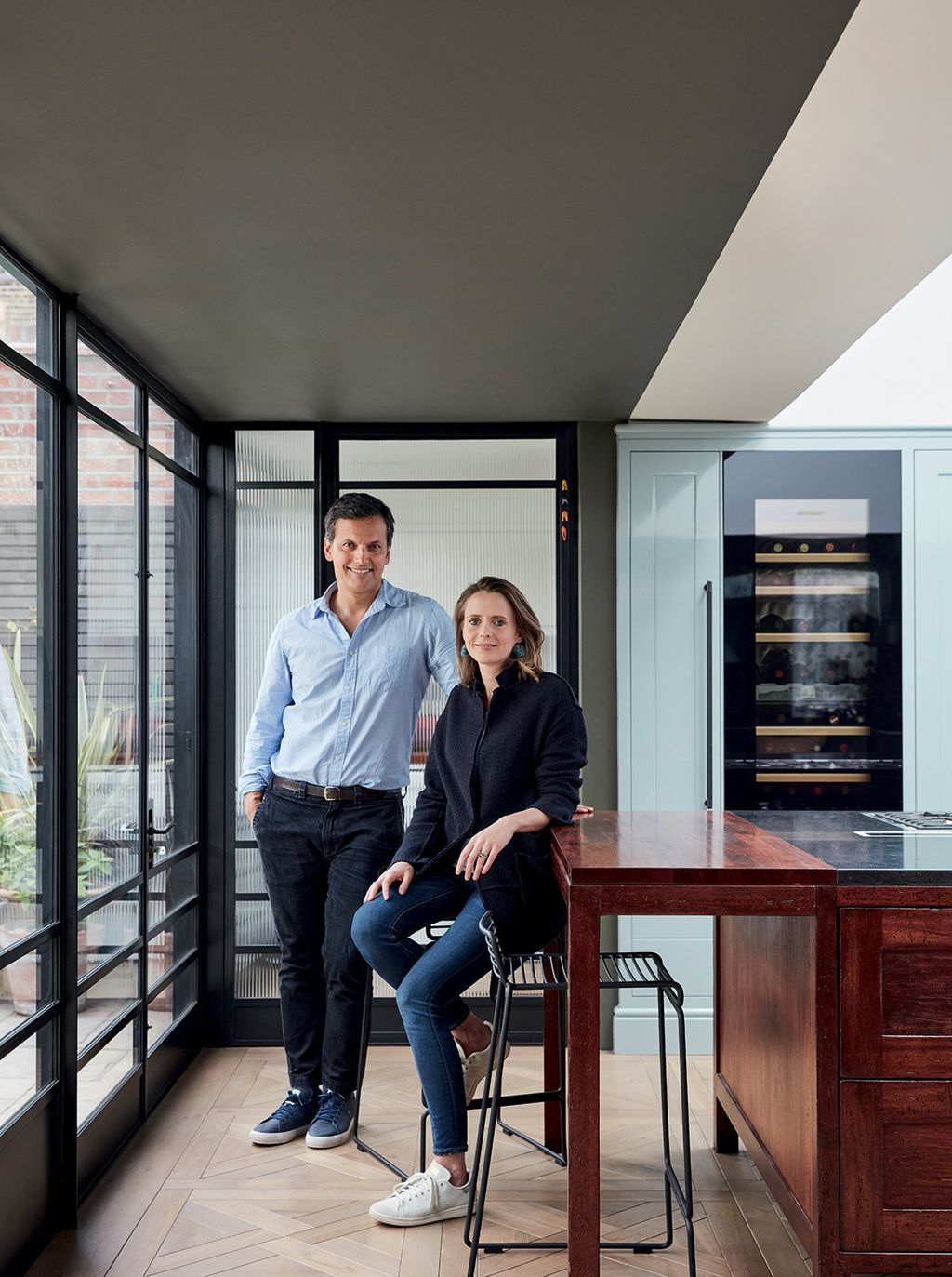 Image may contain Clothing Shoe Footwear Apparel Human Person Pants Furniture Indoors Sitting and Room