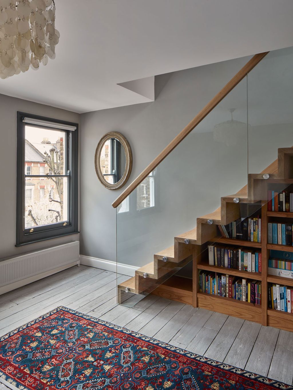 Image may contain Wood Interior Design Indoors Banister Handrail Hardwood Rug Flooring Living Room and Room