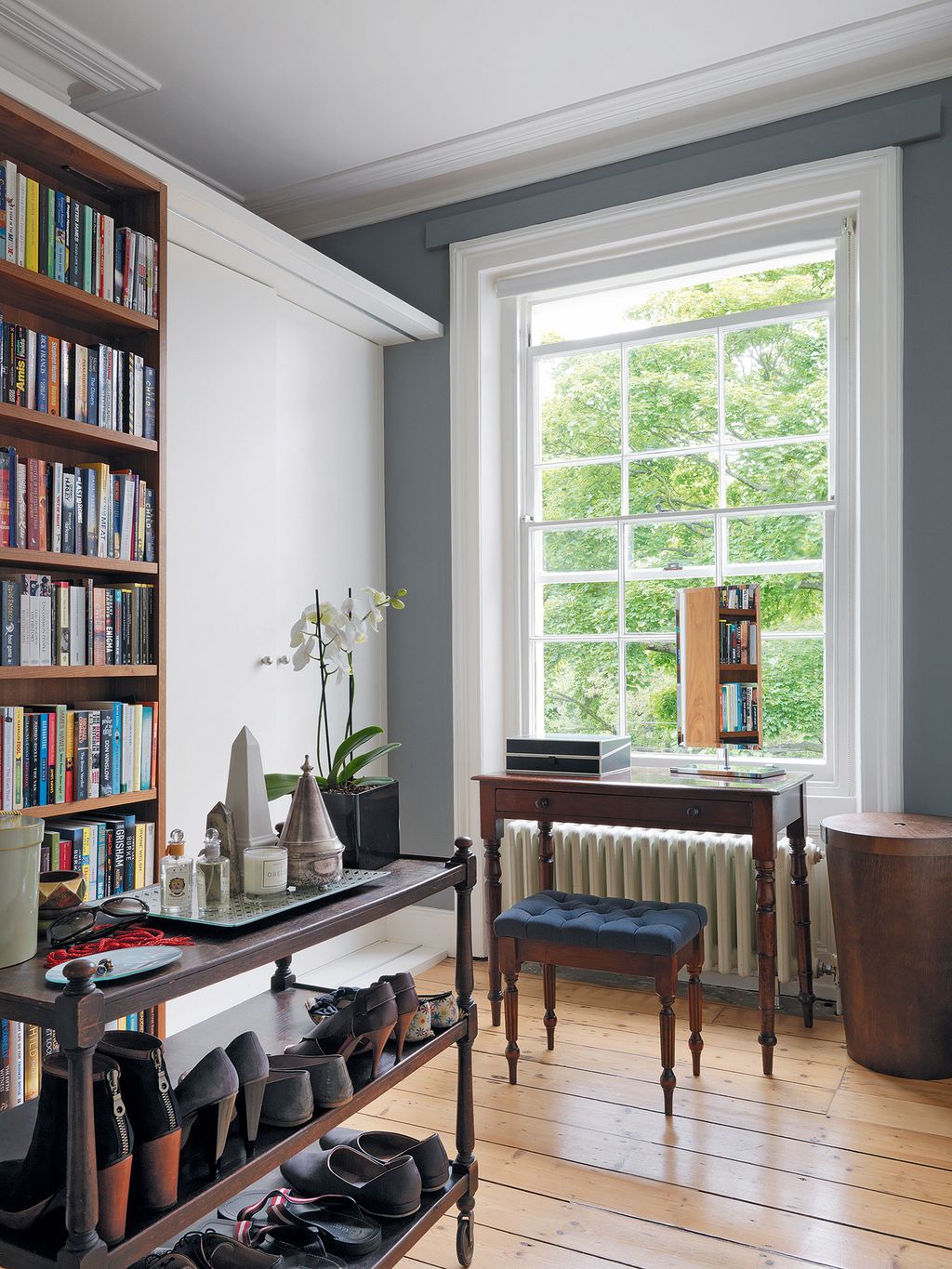 Image may contain Furniture Bookcase Shelf Flooring Wood Living Room Indoors and Room