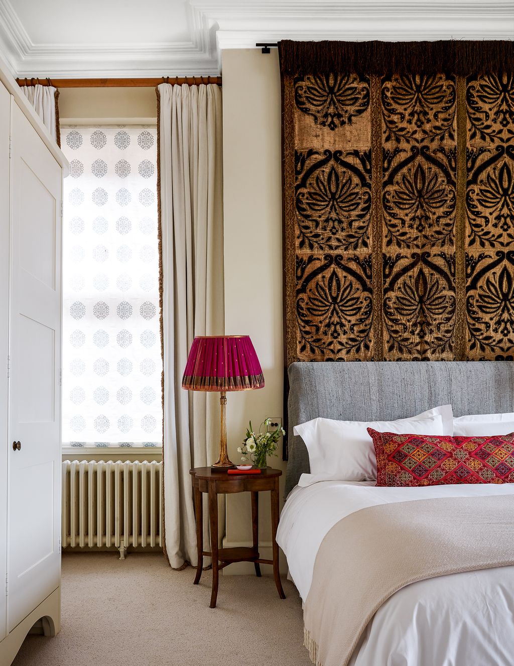 Image may contain Room Indoors Interior Design Bedroom Furniture Home Decor Cushion Lamp Table Lamp and Living Room