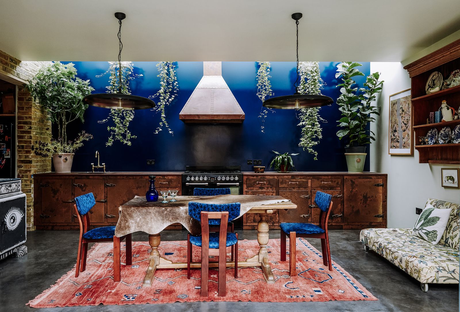 Image may contain Room Indoors Furniture Chair Interior Design Flooring Rug Wood Living Room Hardwood and Kitchen