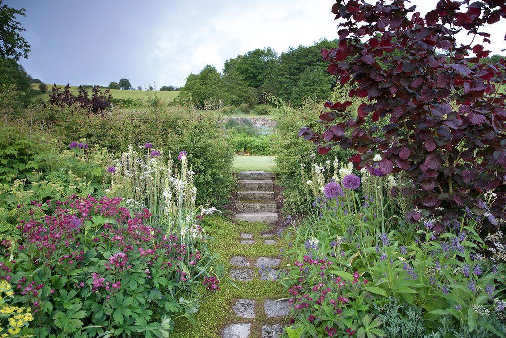 Steps created from stone found on site link the two levels of the walled garden.