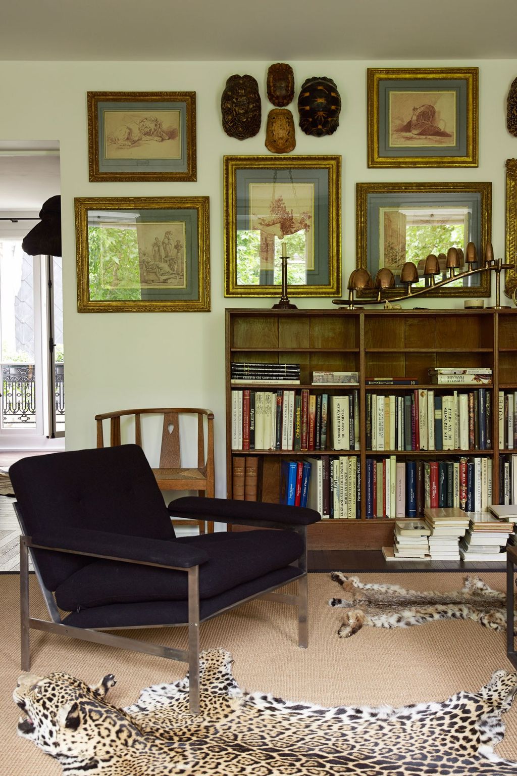 Image may contain Furniture Bookcase Shelf Rug Living Room Room Indoors Wood Chair Interior Design and Flooring