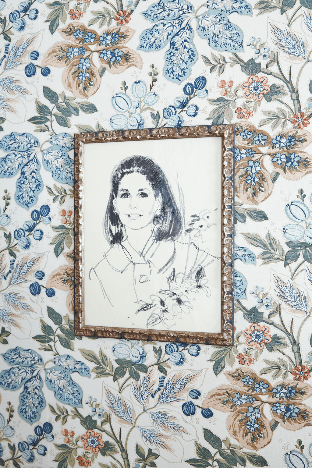 A portrait of Aerins mother Jo Carole Lauder hangs in a guest room the walls of which are covered in a Bennison fabric.