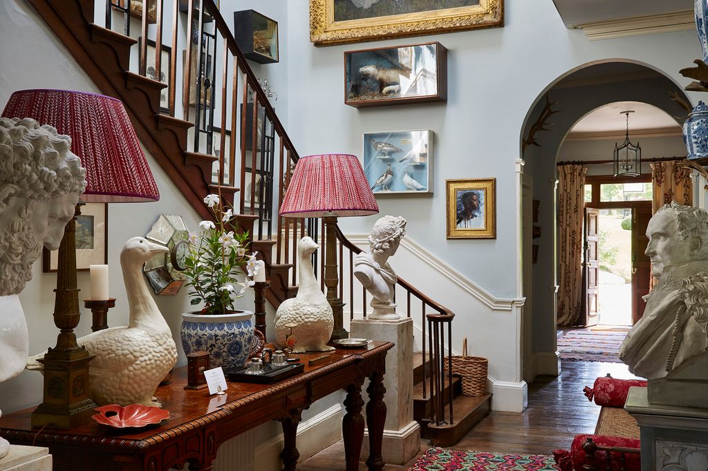 Image may contain Living Room Room Indoors Wood Flooring Hardwood Banister Handrail Interior Design and Lamp